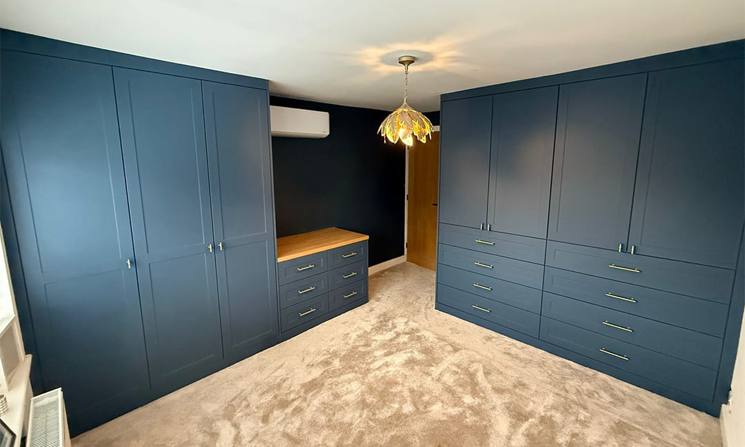 Navy blue shaker fitted wardrobes with chest of drawers