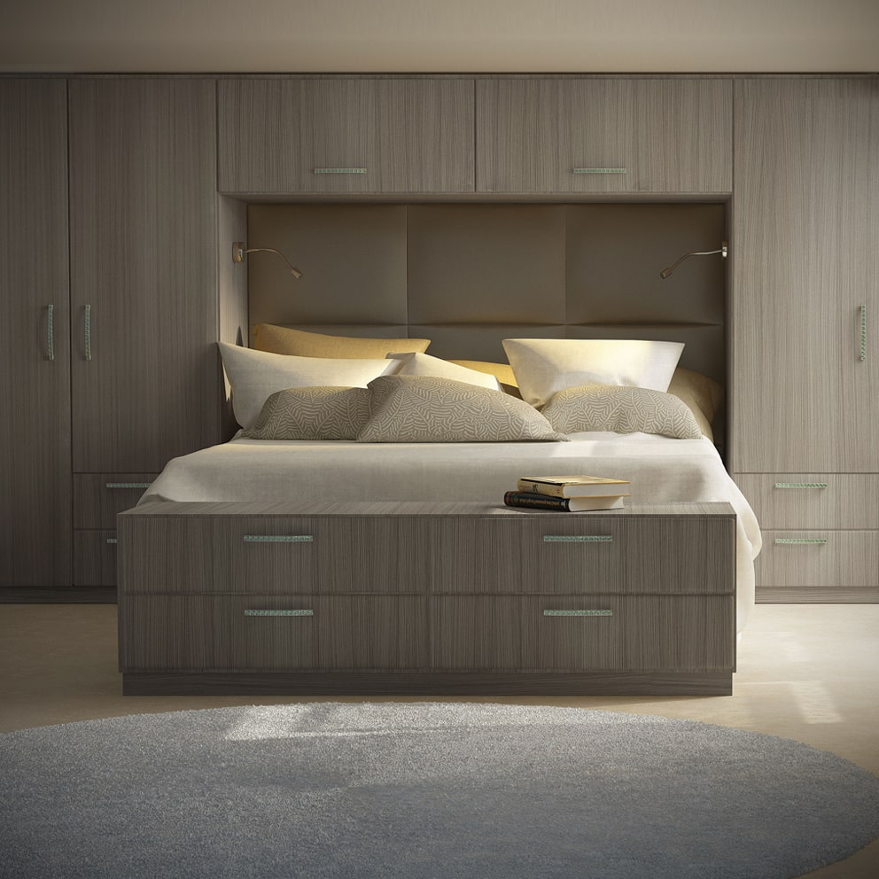 Wood-grain fitted wardrobes surrounding an integrated bed