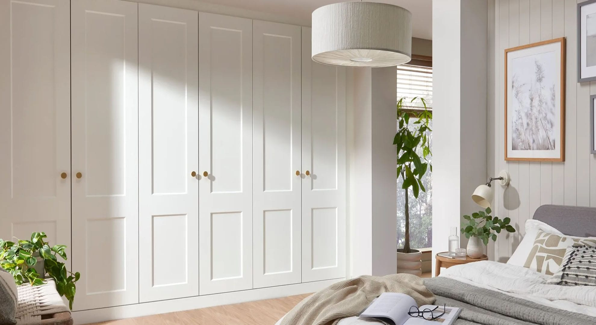 Cream shaker fitted wardrobes in a light modern bedroom